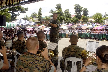 US Navy 070706-N-9195K-009 Gunnery Sgt. Christopher Carpenter conducts members of the U.S. Marine Corps Forces Pacific Band during a performance held at Tabaco City High School in support of Pacific Partnership 2007