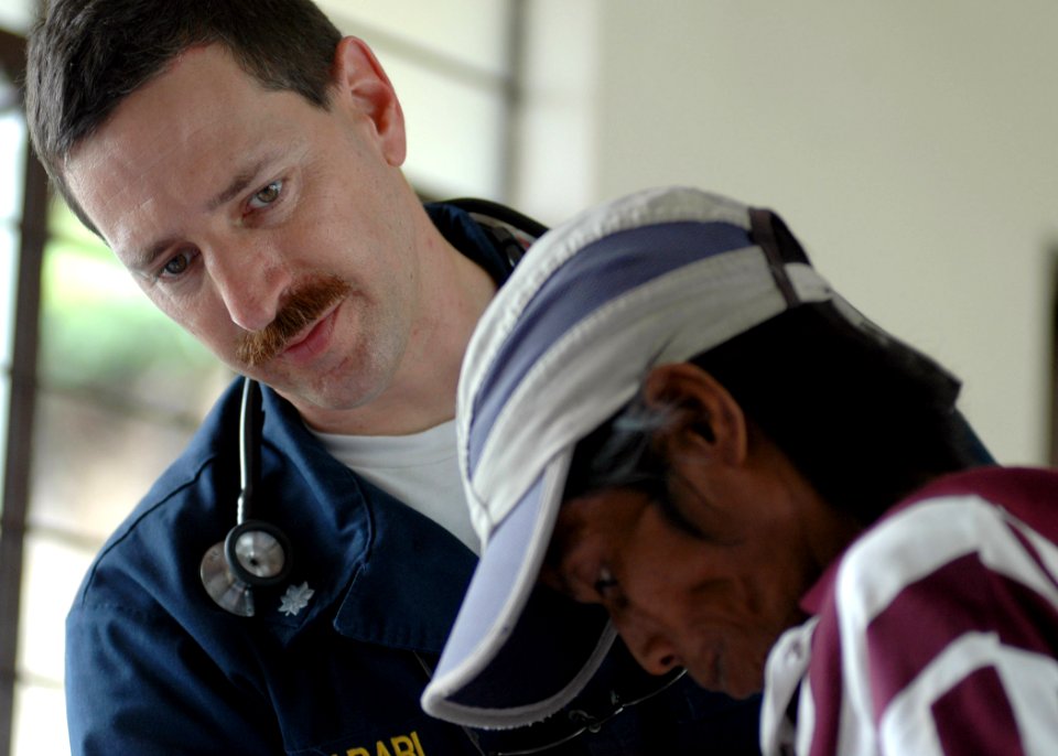US Navy 070706-N-9421C-094 Cmdr. Amir Harari examines a patient at the medical civil-action program (MEDCAP) at Gogon Elementary School in support of Pacific Partnership 2007