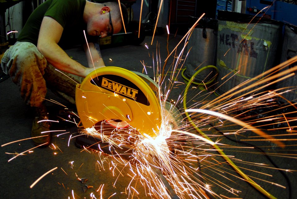 US Navy 070713-N-9760Z-023 Cpl. Jeffery Kline, assigned to the Red Devils of Marine Fighter Attack Squadron (VMFA) 232, cuts doorframes with a friction blade aboard nuclear-powered aircraft carrier USS Nimitz (CVN 68)