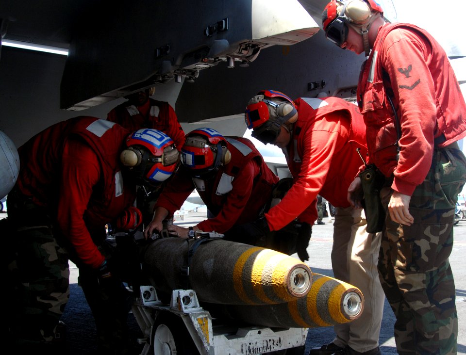 US Navy 070714-N-8923M-005 Sailors from weapons department detach a bomb from an F-A-18 during flight operations aboard Nimitz-class aircraft carrier USS Harry S. Truman (CVN 75)