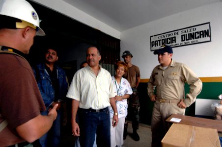 US Navy 070707-N-6278K-015 Ensign Leonard Neal, Construction Battalion Maintenance Unit (CBMU) 202 officer in charge, thanks Dr. Edgar Coto, regional director of Centro De Salud Patricia Duncan, for welcoming his unit to their