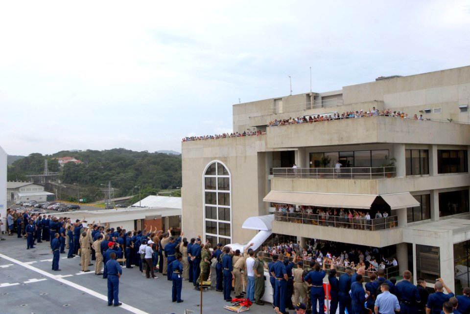 US Navy 070710-N-8704K-077 Crewmembers aboard the flight deck of Military Sealift Command hospital ship USNS Comfort (T-AH 20) wave to people on observation decks alongside the Miraflores locks