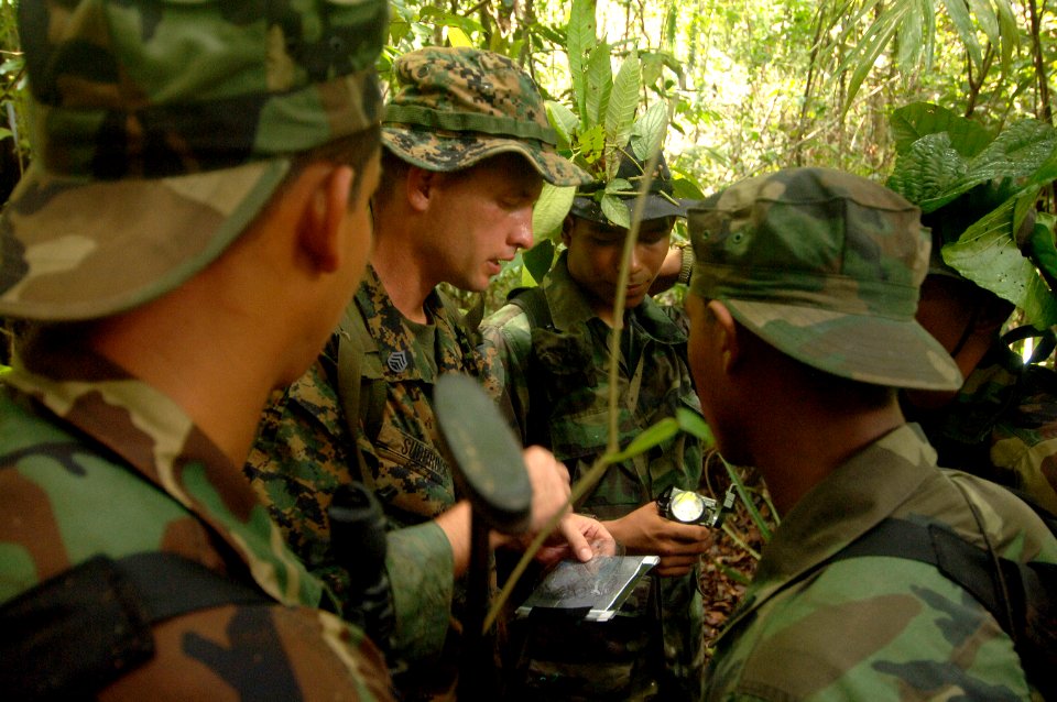US Navy 070713-N-0989H-091 Staff Sgt. William Sudbrock of the U.S. Marine Corps Mobile Training Team assists soldiers from the Panamanian Army with map reading during land navigation and tactical movement exercises during small