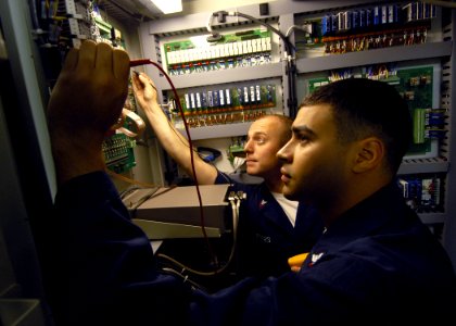 US Navy 070717-N-1598C-008 Aviation Electrician's Mate 2nd Class Curtis Meyers and Aviation Electrician's Mate 2nd Class Carlos Ramos troubleshoot an Aircraft Engine Components Test Stand in the aircraft intermediate maintenanc