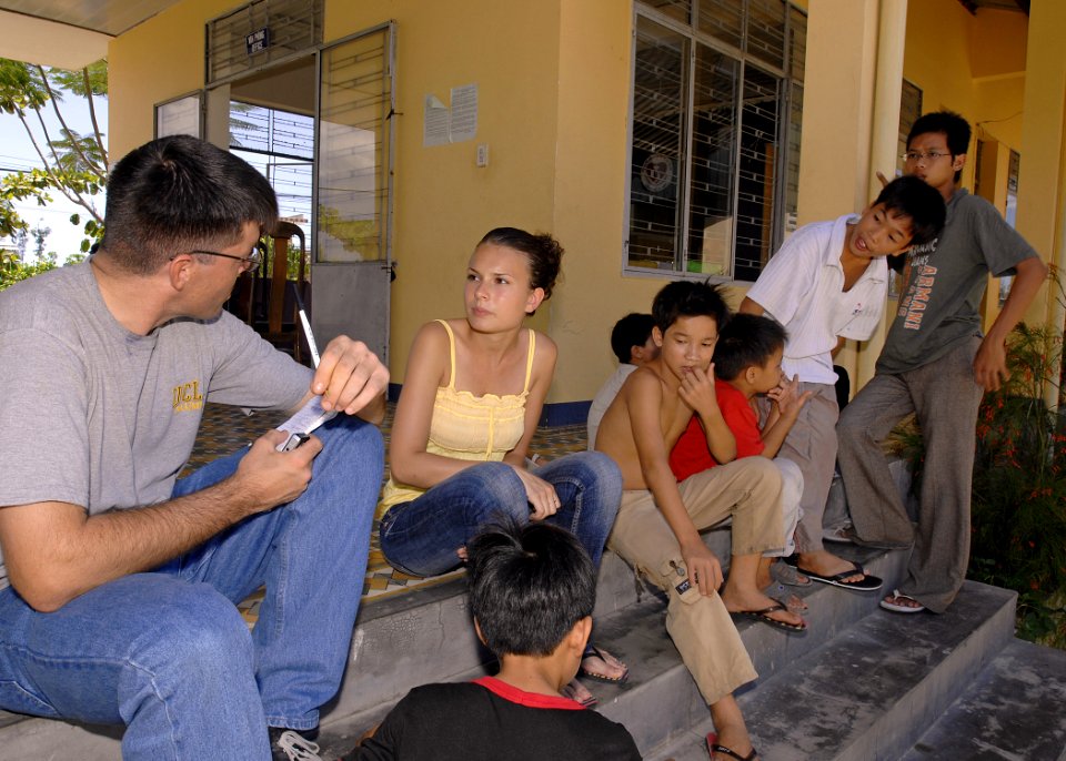 US Navy 070717-N-4954I-121 Mass Communication Specialist 2nd Class Matthew Olay conducts and interview with a volunteer at the Hoi Mai Orphanage
