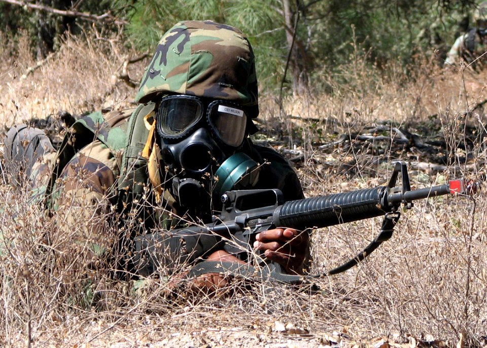 US Navy 070713-N-8547M-050 Culinary Specialist 1st Class Derrick R. Wilson of Naval Mobile Construction Battalion (NMCB) 5 finds concealment to scan the terrain for enemy movement while taking part in a reconnaissance patrol du