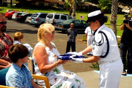 US Navy 070717-N-6674H-093 Master-at-Arms 2nd Class Illianna Thomas of Naval Station Pearl Harbor's Honor Guard presents Jeanne Haack-Marcuci, daughter of Pearl Harbor survivor Chief Gunner's Mate Raymond Haack