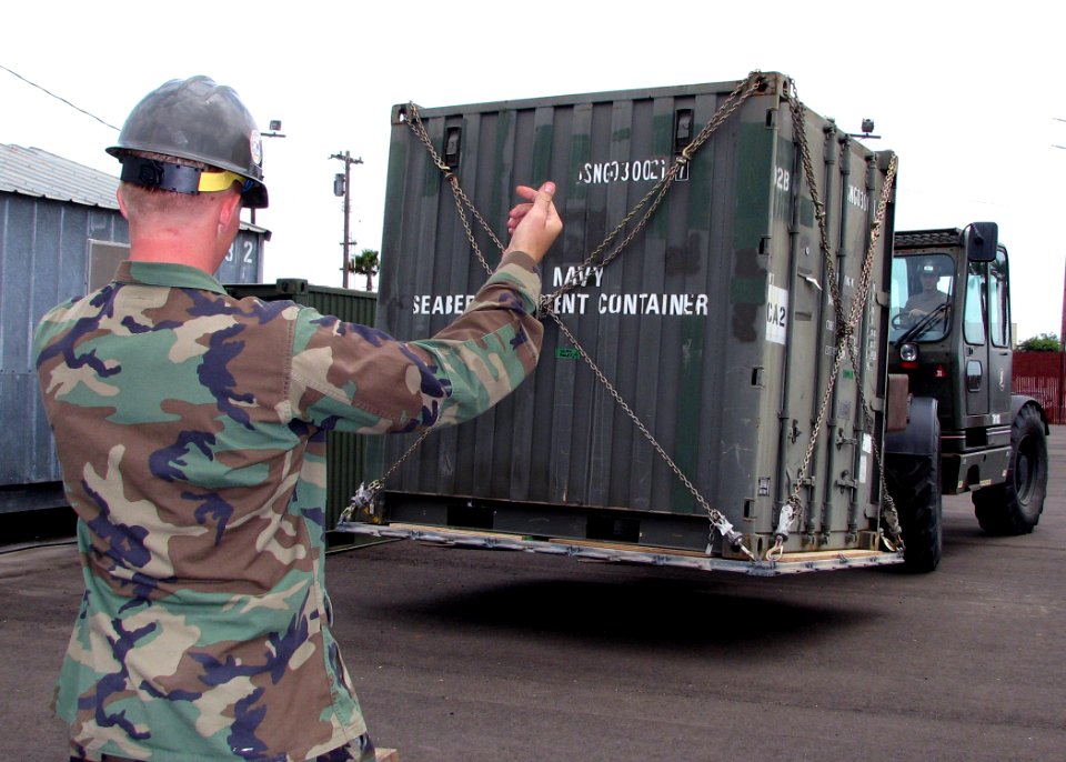 US Navy 070710-N-8547M-018 Construction Electrician Contructionman Apprentice Daniel J. Nelson attached to Naval Mobile Construction Battalion (NMCB) 5 directs a pallet to be brought forward using a forklift during Operation Me