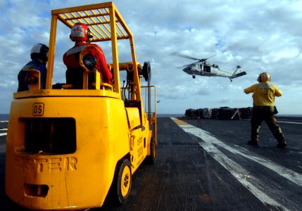 US Navy 070710-N-8923M-057 Sailors stand by after an MH-60S Seahawk attached to the Dusty Dogs of Helicopter Anti-submarine Squadron (HS) 7, drops cargo onto the flight deck aboard the Nimitz-class aircraft carrier USS Harry S