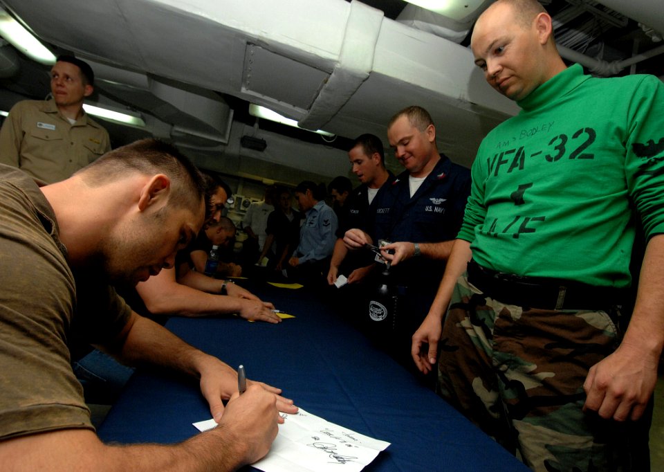 US Navy 070713-N-8923M-164 Ultimate Fighting Championship (UFC) fighter Rich Franklin signs his name for a Sailor during an autograph session on the mess decks aboard Nimitz-class aircraft carrier USS Harry S. Truman (CVN 75)