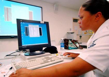 US Navy 070712-N-9758L-048 Information Systems Technician 2nd Class Athena Stovall, assigned to Commander U.S. 3rd Fleet in San Diego, scans the network on her computer for intrusions during a cyber war training course at the S