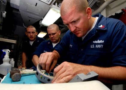 US Navy 070714-N-7981E-064 Sailors assigned to Combat Systems Department inspect repairs made on the gimbal motor of a phase array search antenna for the ship's close-in weapons system aboard Nimitz-class aircraft carrier USS A