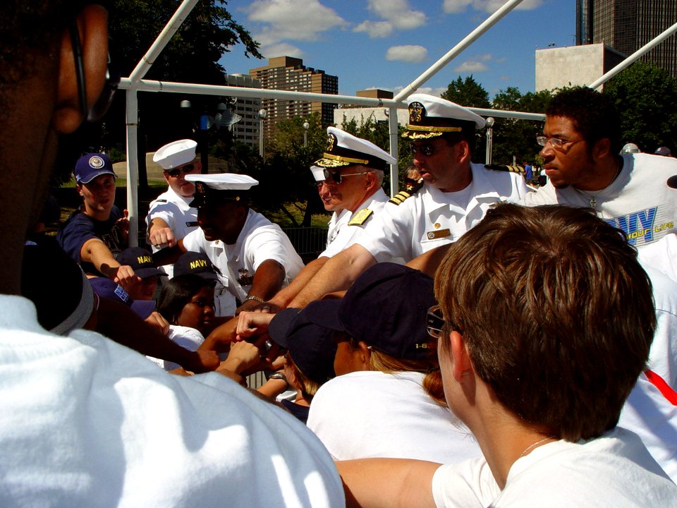 US Navy 070711-N-2888Q-003 Commander, Naval Surface Forces, Vice Adm. Terrance Etnyre (center) and Commanding Officer, Navy Recruiting District Michigan, Cmdr. Greg Maguire participate in a group hoorah with Delayed Entry Progr