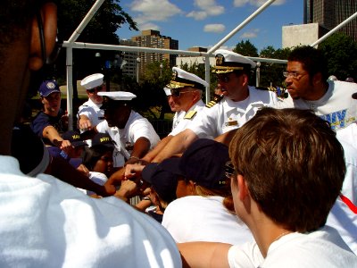 US Navy 070711-N-2888Q-003 Commander, Naval Surface Forces, Vice Adm. Terrance Etnyre (center) and Commanding Officer, Navy Recruiting District Michigan, Cmdr. Greg Maguire participate in a group hoorah with Delayed Entry Progr