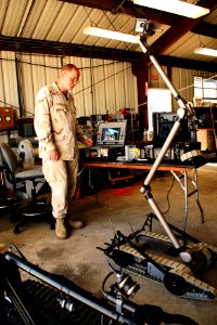 US Navy 070713-N-1328S-004 Fire Controlman 2nd Class Mendel Baker, attached to Space and Naval Warfare Systems Center San Diego, controls an autonomous robot during the Navy Robotic Submarine Competition