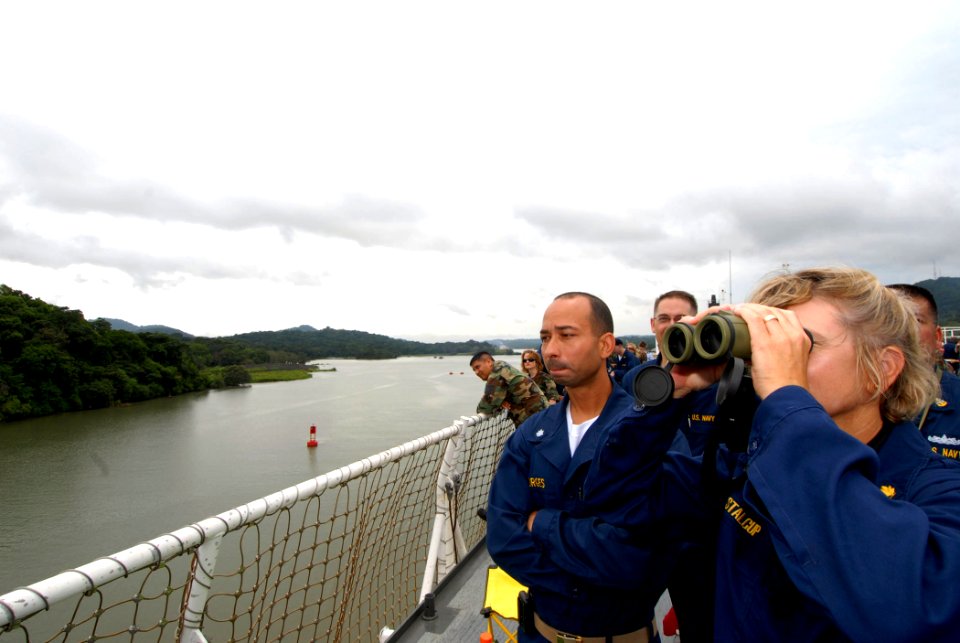 US Navy 070710-N-8704K-009 Cmdr. Anna Stalcup views the Panama Canal through binoculars as Cmdr. Octavio Broges looks on during a steel beach picnic aboard the flight deck of Military Sealift Command hospital ship USNS Comfort