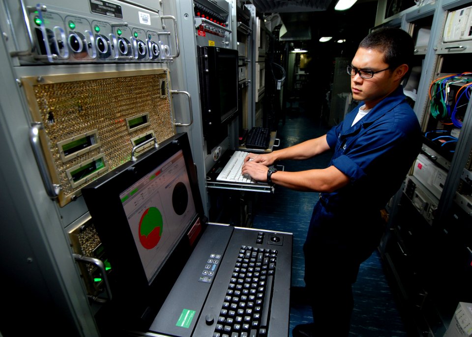 US Navy 070713-N-7981E-108 Information Systems Technician Seaman Jaron Franck monitors the ship's automated digital networking system from the radio communication center aboard Nimitz-Class aircraft carrier USS Abraham Lincoln