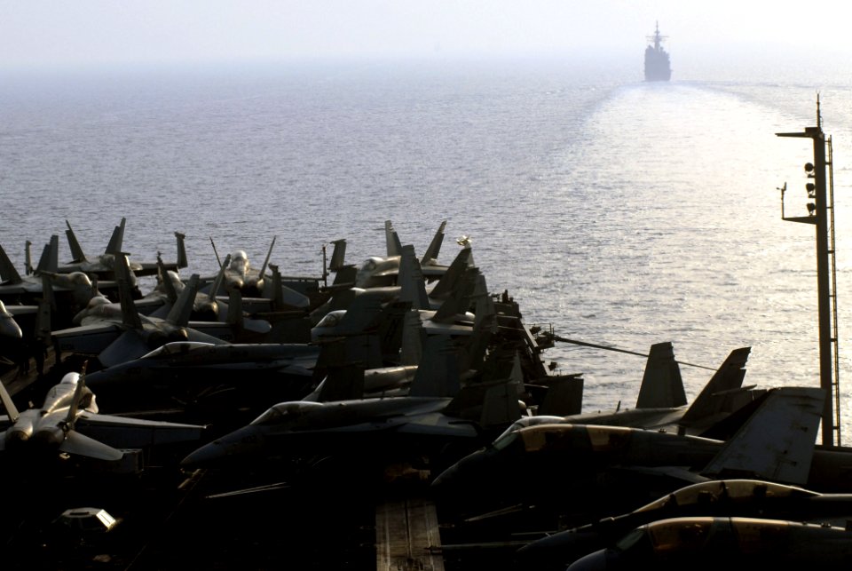 US Navy 070712-N-0890S-020 Aircraft line the flight deck of nuclear-powered aircraft carrier USS Nimitz (CVN 68), as the guided-missile cruiser USS Princeton (CG 59) guides the carrier through the Straits of Hormuz