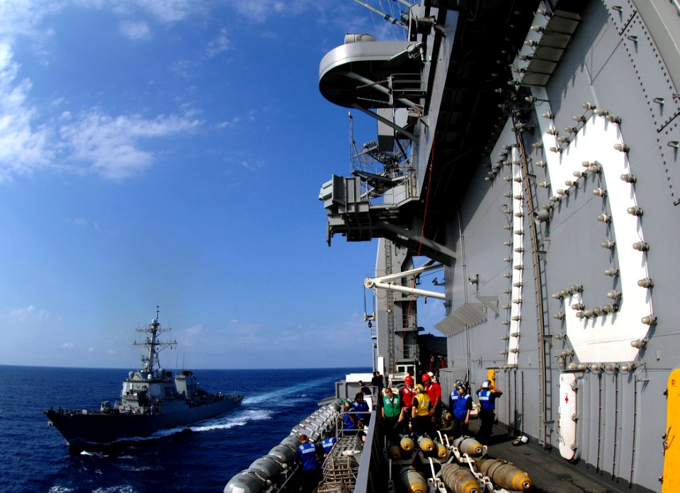 US Navy 070711-N-8923M-020 Sailors from deck department stand by on the starboard side of the island of Nimitz-class aircraft carrier USS Harry S. Truman (CVN 75) as guided-missile destroyer USS Carney (DDG 64) pulls alongside