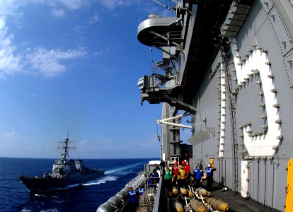 US Navy 070711-N-8923M-020 Sailors from deck department stand by on the starboard side of the island of Nimitz-class aircraft carrier USS Harry S. Truman (CVN 75) as guided-missile destroyer USS Carney (DDG 64) pulls alongside