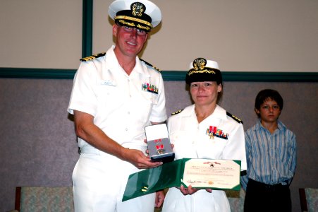 US Navy 070714-N-8102J-011 Cmdr. Kelly Nielsen receives the Bronze Star Medal from Cmdr. Joseph Sweeney, commanding officer of Naval Air Systems Command 0466 Det. A