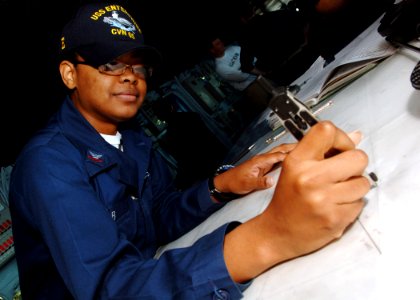 US Navy 070715-N-5928K-002 Quartermaster 2nd Class Roscille Cobb plots the ship's course on the bridge of nuclear-powered aircraft carrier USS Enterprise (CVN 65)
