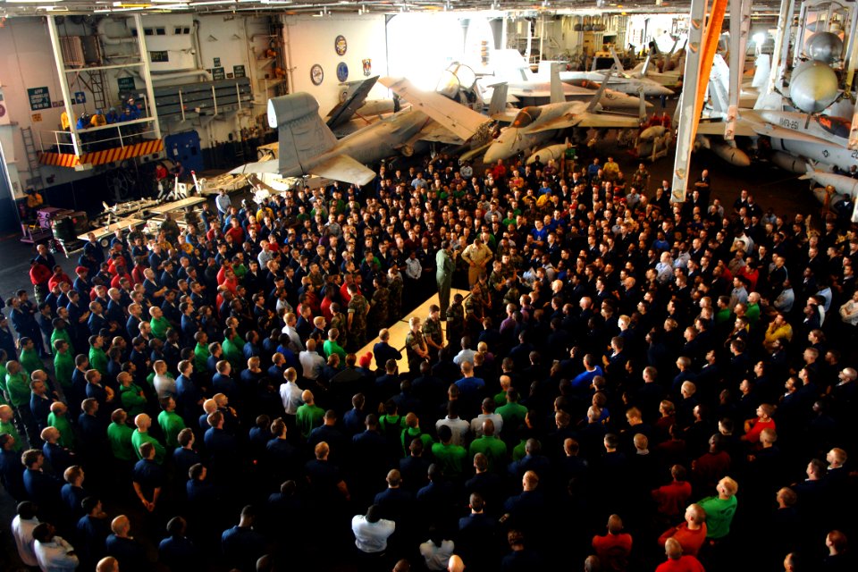 US Navy 070717-N-5928K-003 Commanding Officer Capt. Ron Horton speaks to Sailors during an E-4 and below captain's call in the hangar bay of nuclear-powered aircraft carrier USS Enterprise (CVN 65)