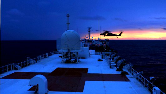 US Navy 070716-N-0194K-108 An MH-60S Seahawk, from Helicopter Sea Combat (HSC) Squadron 28, conducts night vertical replenishment training aboard Military Sealift Command hospital ship USNS Comfort (T-AH 20) photo