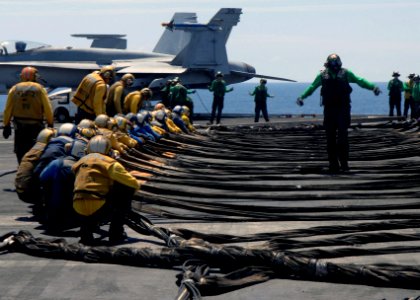 US Navy 070716-N-3729H-061 Flight deck Sailors ready the barricade during flight deck drills aboard Nimitz-class aircraft carrier USS John C. Stennis (CVN 74) photo