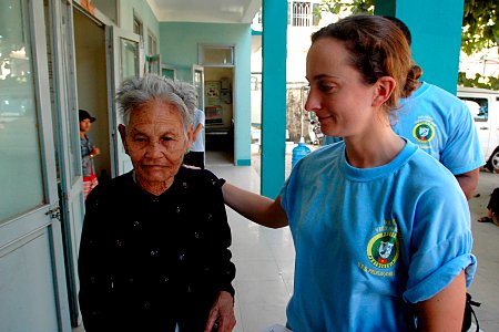 US Navy 070719-N-9421C-077 Lt. Lydia Battey, attached to Naval Health Clinic Hawaii, assists an elderly Vietnamese women to her seat before issuing her prescribed medication at Nai Hiem Dong Ward Station