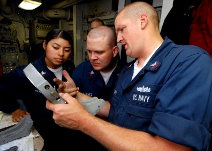 US Navy 070714-N-7981E-061 Sailors assigned to combat systems department inspect repairs made on the gimbal motor of a phase array search antenna for the ship's close-in weapons system aboard Nimitz-class aircraft carrier USS A