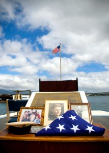 US Navy 070717-N-6674H-009 A combination cover, a few photographs and the American flag are placed on display in memory of Pearl Harbor survivor Chief Gunner's Mate Raymond Haack during a burial at sea held at the USS Uta