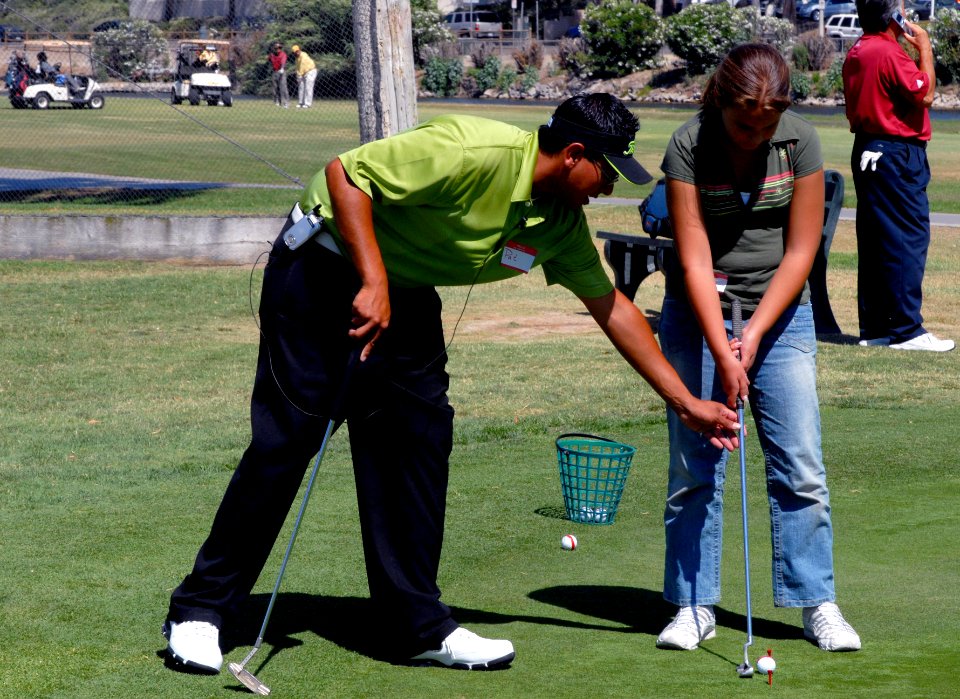 US Navy 070718-N-9604C-006 Golf professional Pat Diaz gives a young golfer a few pointers on putting at the Chula Vista Municipal Golf Course