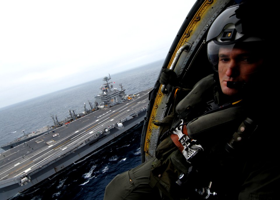 US Navy 070717-N-7981E-923 Aviation Warfare Systems Operator 2nd Class Patrick Treman, of the Golden Falcons of Helicopter Anti-submarine Squadron (HS) 2, acts as crew chief of an HH-60H Seahawk