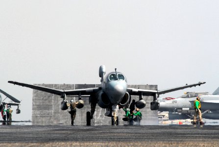 US Navy 070720-N-8119R-083 An EA-6B Prowler, assigned to the Black Ravens of Tactical Electronic Warfare Squadron (VAQ) 135, lowers its wings while Sailors do last minute safety checks before launch aboard nuclear-powered aircr