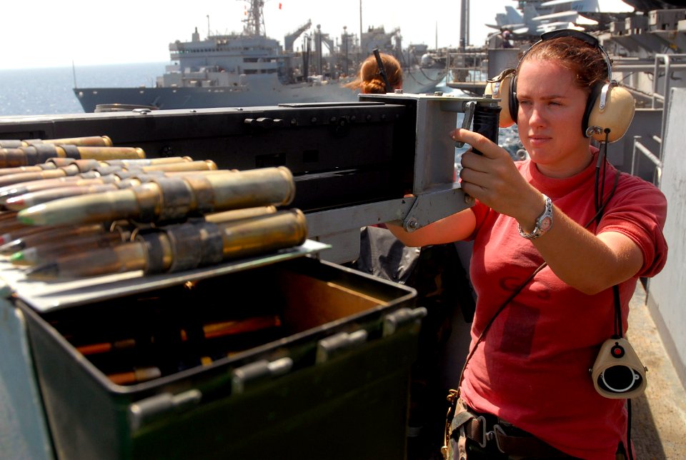 US Navy 070718-N-0890S-008 Aviation Ordnanceman 3rd Class Susan Holt mans the starboard bow .50-caliber watch on nuclear-powered aircraft carrier USS Nimitz (CVN 68) during replenishment at sea with Military Sealift Command fas