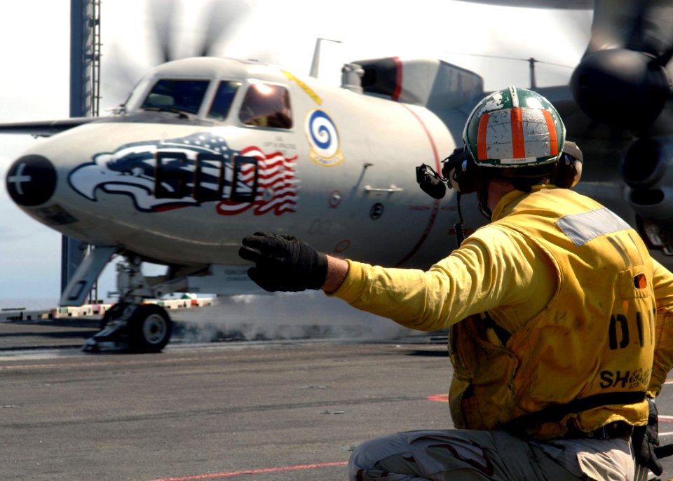 US Navy 070718-N-5928K-004 Lt. Cmdr. Joseph Leber signals to launch a E-2C Hawkeye from the flight deck of nuclear-powered aircraft carrier USS Enterprise (CVN 65)