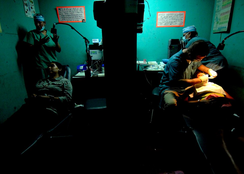 US Navy 070719-N-6278K-026 Capt. Joseph Rusz, a dental officer, examines a patient's teeth at the Jose Schendal Health Center. Rusz is assigned to the U.S. Navy hospital ship USNS Comfort (T-AH 20)