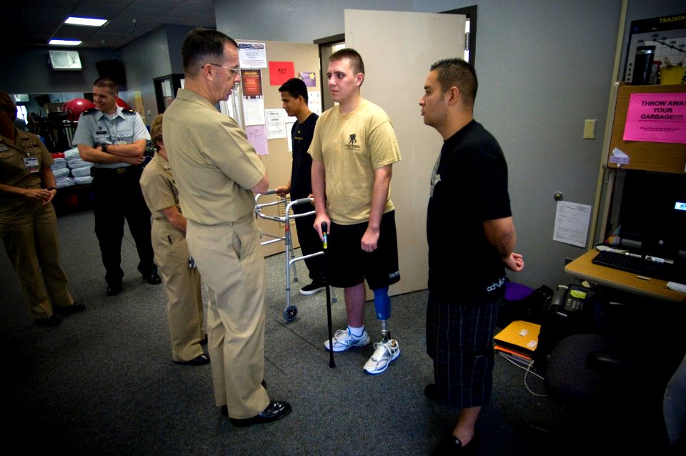 US Navy 070718-N-0696M-260 Chief of Naval Operations (CNO) Adm. Mike Mullen speaks with amputee service members undergoing therapy at Naval Medical Hospital Balboa