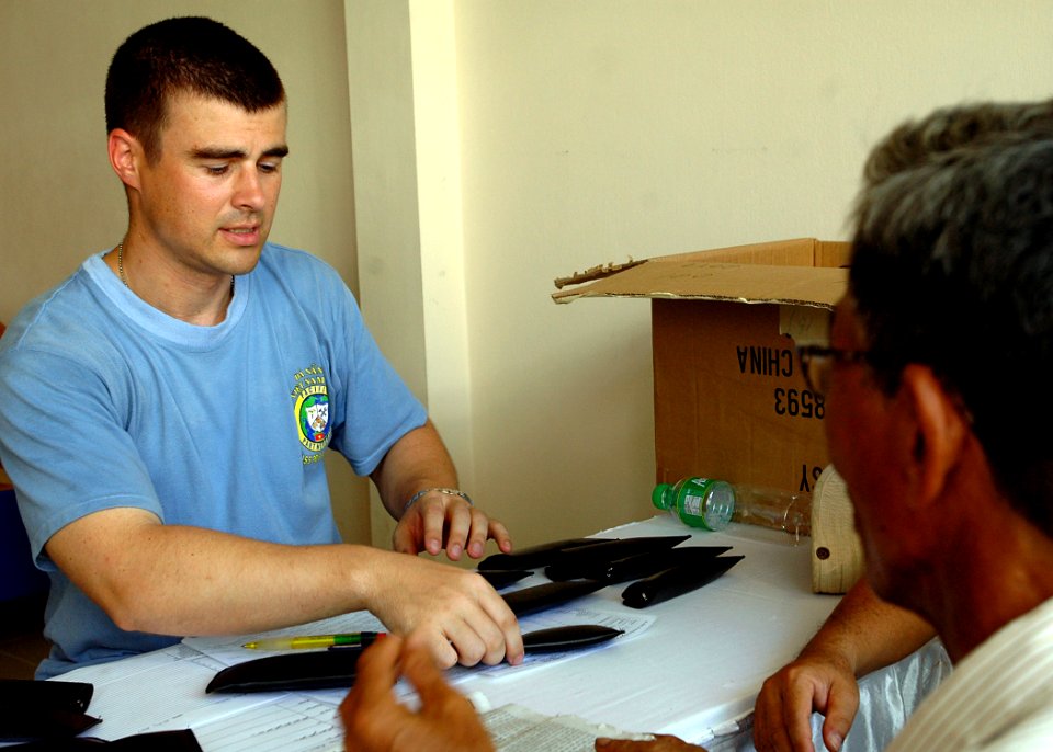 US Navy 070720-N-1752H-042 Tech. Sgt. Rayno Boivin, of the U.S. Air Force 36th Medical Operation Squadron, issues a new pair of glasses to a local citizen during a medical and dental civil action program at the Man Thai Ward Me