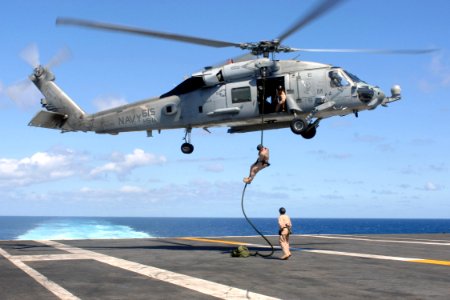 US Navy 070720-N-5928K-007 Explosive ordnance disposal technicians assigned to Explosive Ordnance Disposal Mobile Unit (EODMU) 2, Det. 26, conduct a fast rope exercise from an HH-60H Seahawk