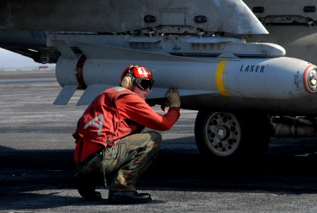US Navy 070718-N-8119R-052 Aviation Ordnanceman Airman Cory Smith, assigned to the Sunliners of Strike Fighter Squadron (VFA) 81, arms a Maverick missile prior to an F-A-18A Hornet