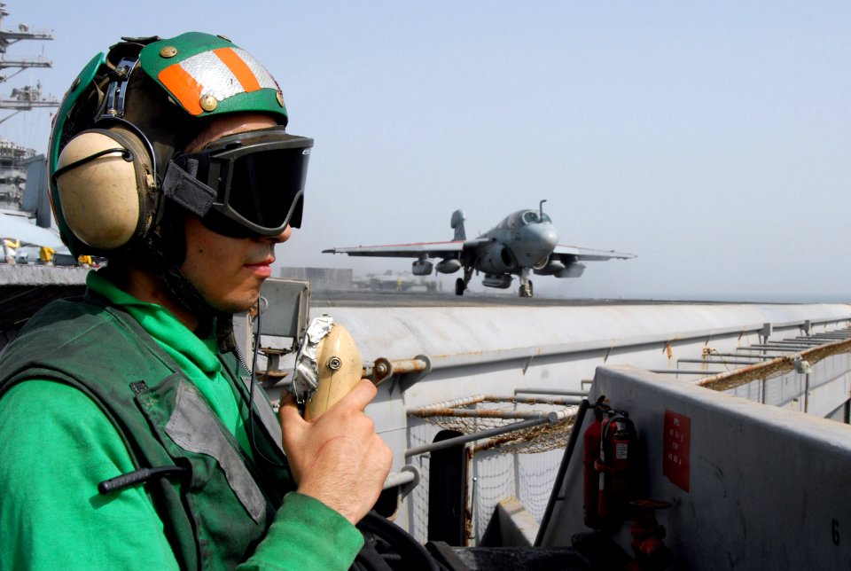 US Navy 070720-N-8119R-087 viation Boatswain's Mate (Equipment) Airman Sergio Rojas stands bow safety during flight operations as an EA-6B Prowler, assigned to the Black Ravens of Tactical Electronic Warfare