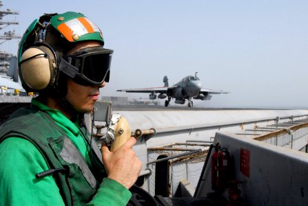 US Navy 070720-N-8119R-087 viation Boatswain's Mate (Equipment) Airman Sergio Rojas stands bow safety during flight operations as an EA-6B Prowler, assigned to the Black Ravens of Tactical Electronic Warfare