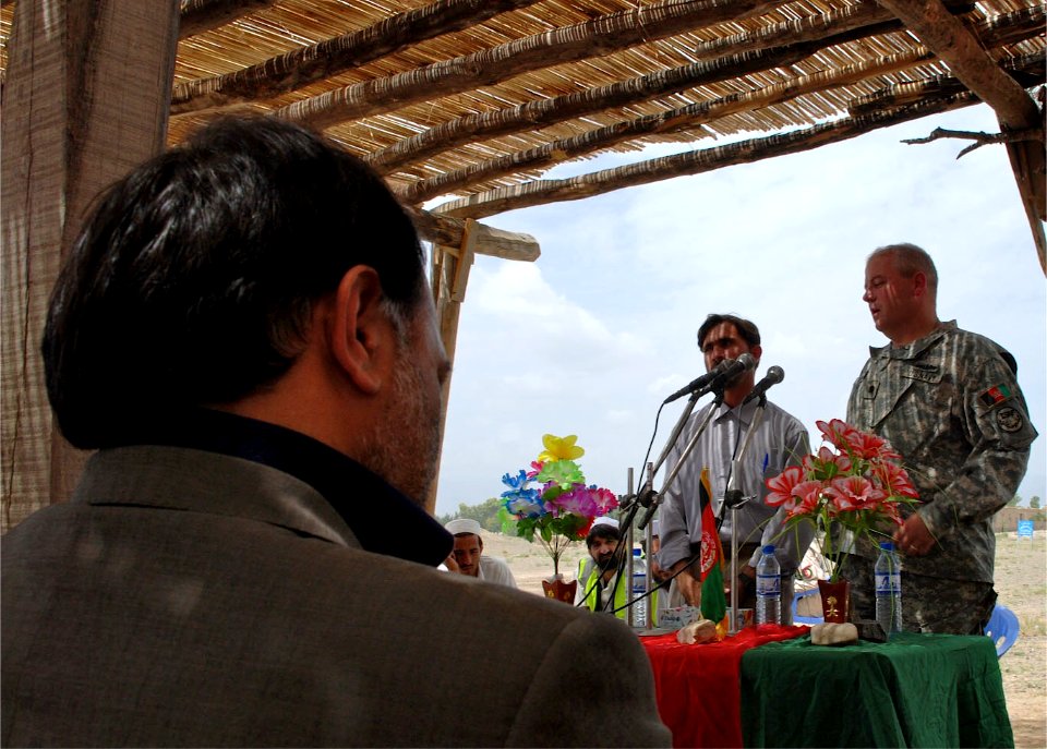 US Navy 070723-N-3385W-086 U.S. Navy Cmdr. David Adams, commanding officer of Provincial Reconstruction Team Khost, explains that education is the future of Afghanistan at the groundbreaking ceremony for the new university road