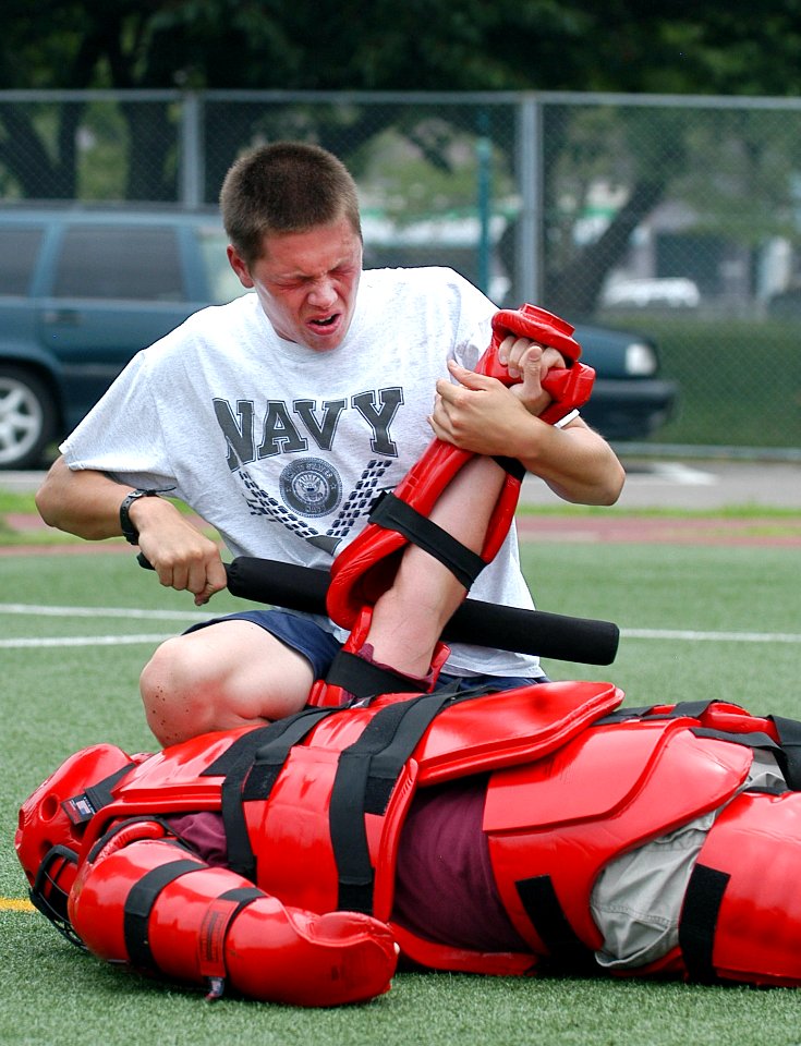 US Navy 070719-N-0807W-143 Mineman Seaman Wes E. Akin, assigned to mine warfare ship USS Guardian (MCM 5), performs a mechanical advantage control hold after being sprayed with oleoresin capsicum, or pepper spray, during a requ