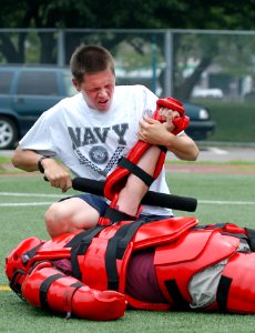 US Navy 070719-N-0807W-143 Mineman Seaman Wes E. Akin, assigned to mine warfare ship USS Guardian (MCM 5), performs a mechanical advantage control hold after being sprayed with oleoresin capsicum, or pepper spray, during a requ