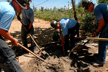 US Navy 070719-N-9421C-107 Seabees attached to Naval Mobile Construction Battalion (NMCB) 7 mix cement that will be used as foundation for a playground at Hoi Mai Orphanage