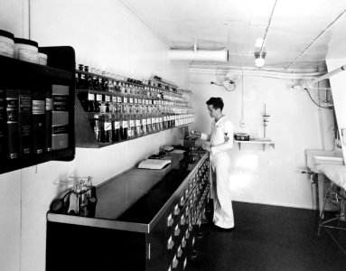 USS Charger (ACV-30) preparing a perscription in the ship's dispensary, 1942 (28626728878)