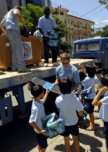 US Navy 070724-N-4954I-055 Capt. Bruce Stewart, Pacific Partnership mission commander, hands out donated toys as part of a Project Handclasp ceremony for the Children of Vietnam organization photo